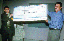 Mr Manoj Shirodkar, Country Director, Herbalife International, handing over a cheque of Rs 15 lakh to Mr Pradeep Singh, National Director, SOS Children�s Villages of India