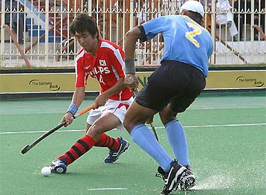 Indian defender Sandeep Singh tackles South Korean forward Kyu Yeob Jang during their semi-final match at the 5th Junior Men�s Asia Cup hockey tournament in Karachi 