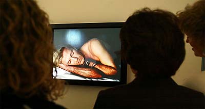 Visitors to London's National Portrait Gallery watch a film on England soccer captain and Real Madrid midfielder David Beckham 