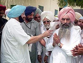 The Punjab Chief Minister, Capt Amarinder Singh, accepts applications from people after visiting Dera Roomiwala in Bathinda on Wednesday. 