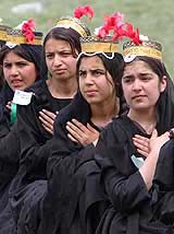 Afghan schoolgirls perform during a ceremony to mark the 12th anniversary of the Mujahideens' victory over the Communist regime