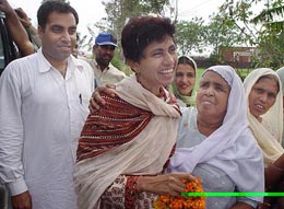 Congress candidate Kumari Selja interacts with rural women during a campaign rally at Jansui village