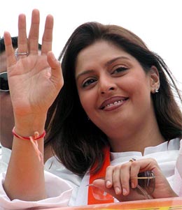 Cine star Nagma gestures during an election campaign for Congress candidate Sandeep Dikshit (not in picture) at the Trilok Puri area in New Delhi on Thursday. 