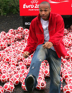 Arsenal's French striker Thierry Henry kicks a football during the launch of a soft drinks promotional campaign