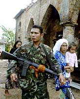 A Thai soldier stands guard outside Krue Se mosque in Thailand�s largely Muslim province of Pattani, 1,150 km south of Bangkok