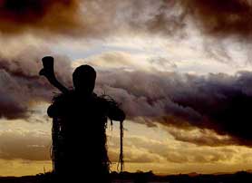 A Fijian warrior stands guard outside the Government House where the former President of Fiji Ratu Sir Kamisese Kapaiwai Tuimacilai Mara lies in-state