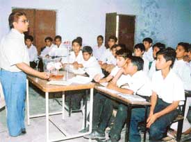 Mr Ramesh Kumar gives a demonstration on a science topic as he takes a class at Government High School