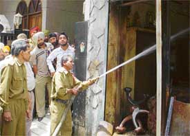A fireman tries to control the fire at a crackers� shop at Street No. 11, Field Gunj, in Ludhiana