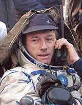 US astronaut Michal Hoale speaks on the phone after landing 47 km northeast of Arkalyk in northern Kazakhstan on Friday.