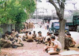 Security personnel await to be deputed for poll duties at various places in Punjab at Ludhiana railway station