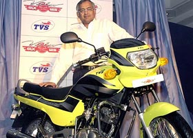 TVS Motor Chairman and Managing Director Venu Srinivasan poses with the newly-launched TVS Victor GLX 125 in Chennai 