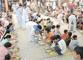 Devotees take part in a �langar� organised by the Sri Sathya Sai Seva Organisation at Government High School, Hallo Majra, Chandigarh