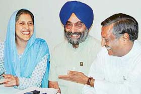 Mr Satya Pal Jain, BJP candidate, shares a joke with Ms Harjinder Kaur, SAD councillor, at a press conference in Chandigarh