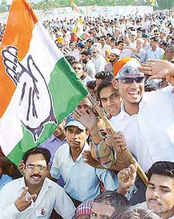 People greet Congress President Sonia Gandhi on her arrival at an election rally in Chandigarh