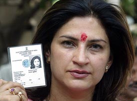 Bollywood actors Kunika Sadanand shows her voter identity card during a protest to demand voting rights
