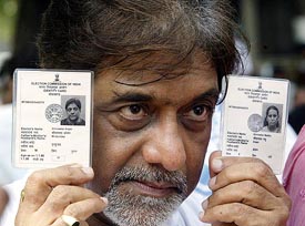 Bollywood actors Anjan Srivastava shows his voter identity card during a protest to demand voting rights