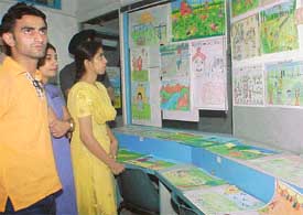 Visitors at a painting exhibition held by the schoolchildren in Ludhiana 