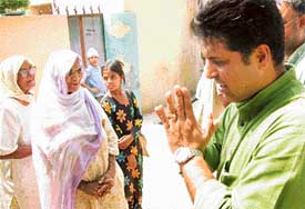 Mr Manish Tiwari, candidate of the Congress, seeks votes from villagers