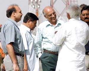 Election observer Anand Kumar talk to RJD chief Laloo Prasad Yadav at Patna airport on Sunday
