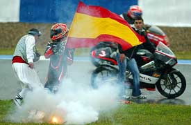 Spanish Hector Barbera celebrates with Spanish flag after the 125cc race at the Spanish Motorcycle Grand Prix in Jerez