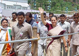 AICC President Sonia Gandhi waves to the crowd after addressing an election rally at Luhnu ground