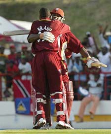 West Indies all-rounder Dwayne Bravo hugs teammate Ridley Jacobs after beating England in the 6th ODI to take a 2-1 lead in the rain-marred seven-match series at Gros Islet, St. Lucia, on Sunday