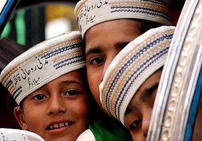 Pakistani children attend a religious procession, organised to mark the birth anniversary of Prophet Mohammad