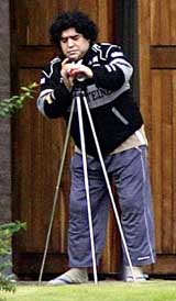 Former Argentine football star Diego Maradona adjusts a telescope at a private home in the town of General Rodriguez, on the outskirts of Buenos Aires