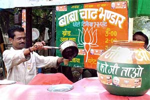 A tea vendor utilises his price list and other utensils to highlight the BJP symbol in Bhopal