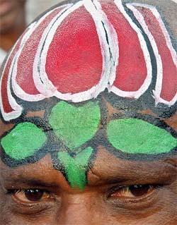 A BJP supporter with his head painted in party colours attends an election rally addressed by Prime Minister Atal Bihari Vajpayee in Chennai