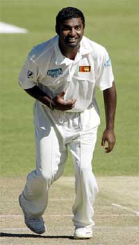Sri Lanka spinner Mutiah Muralitharan smiles after taking the wicket of Zimbabwe batsman Tatenda Taibu during day one of the first Test at the Harare Sports Club