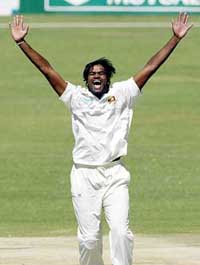 Sri Lanka's Nuwan Zoysa celebrates taking the wicket of Zimbabwe batsman Dion Ebrahim