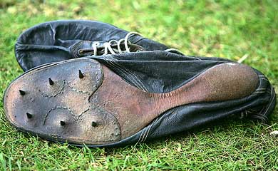 The running shoes used by Britain's Sir Roger Bannister when he ran the first sub-four-minute mile in 1954 lie on the grass at Pembroke College, Oxford
