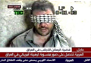 A television grab from Dubai-based Al Arbiya television shows what it says is a videotape showing an American engineer working for the Pentagon held hostage in Iraq