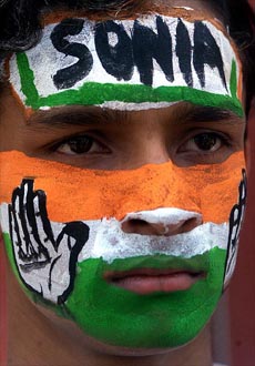 A Congress activist wears face painted in party colours during an election campaign in Kolkata 