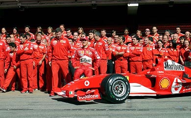 Ferrari Formula One world champion Michael Schumacher of Germany and his Ferrari team pose during a photo call ahead of the Spanish Formula One Grand Prix