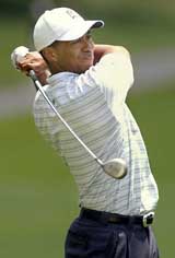 Tiger Woods hits an approach shot to the hole on the first day of the Wachovia Championship at the Quail Hollow Club in Charlotte, North Carolina