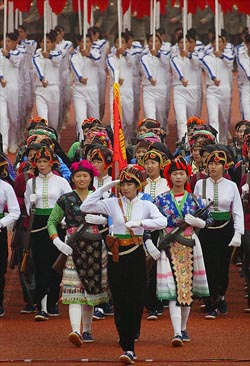 Ethnic Vietnamese march during celebrations to mark the 50th anniversary of the defeat of French forces in Dien Bien Phu