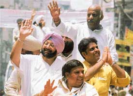 Capt Amarinder Singh, Chief Minister of Punjab, waves to the crowd during a road show in Ludhiana on Saturday. Mr Manish Tiwari, candidate of the Congress