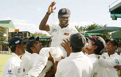 Sri Lankan cricketers chair Muttiah Muralitharan after he broke the world record for highest Test wickets 