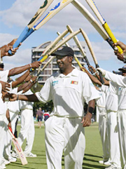 being given a hero's welcome by teammates as he returns to the pavillion