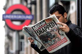 A man reads a copy of the Daily Mirror newspaper which flashed photographs of a British soldier abusing an Iraqi prisoner