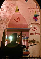 A policeman stands guard outside a temple on the eve of Lok Sabha polls in J&K