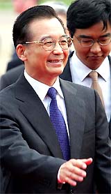 China�s Premier Wen Jiabao smiles as he arrives at Heathrow airport in London 