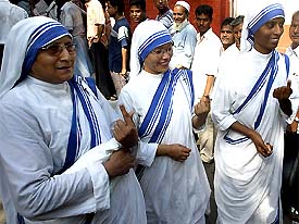 Sisters of the Missionaries of Charity, founded by Mother Teresa, show their fingers marked with voting ink after casting votes in Kolkata