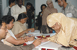 Muslim voters cast their vote at a polling booth in the Old City area for the final round of the Lok Sabha election in the Capital on Monday.