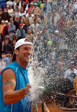 Spain's Carlos Moya sprays champagne after defeating Argentina's David Nalbandian in the final of the men's clay court Italian Open tennis tournament