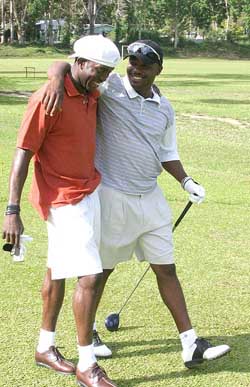 West Indies captain Brian Lara walk with Blackburn Rovers striker Dwight Yorke during a friendly golf game between the two friends at the St. Andrews Golf Course