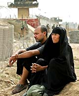 Iraqi parents wait outside the Abu Ghraib prison 