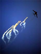 A US Air Force jet releases flares as it flies over the western Afghan city of Herat